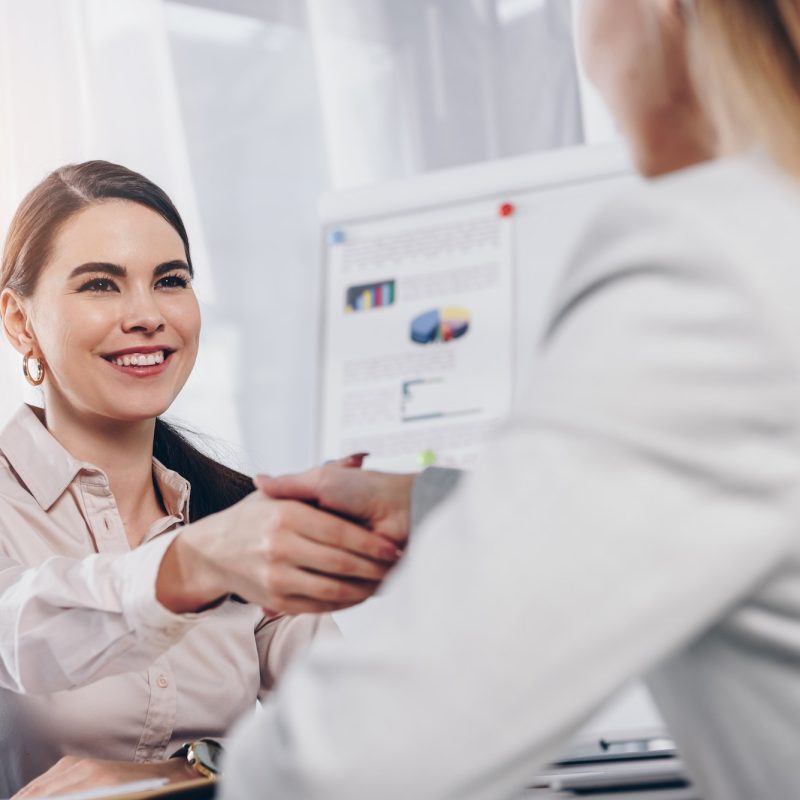 recruiter-smiling-and-shaking-hands-with-employee-at-job-interview-in-office.jpg